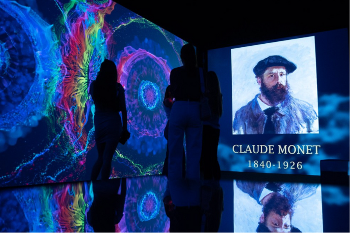 Visitors observing Claude Monet art projection